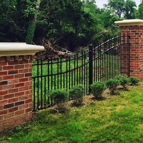 Decorative metal fence and masonry columns